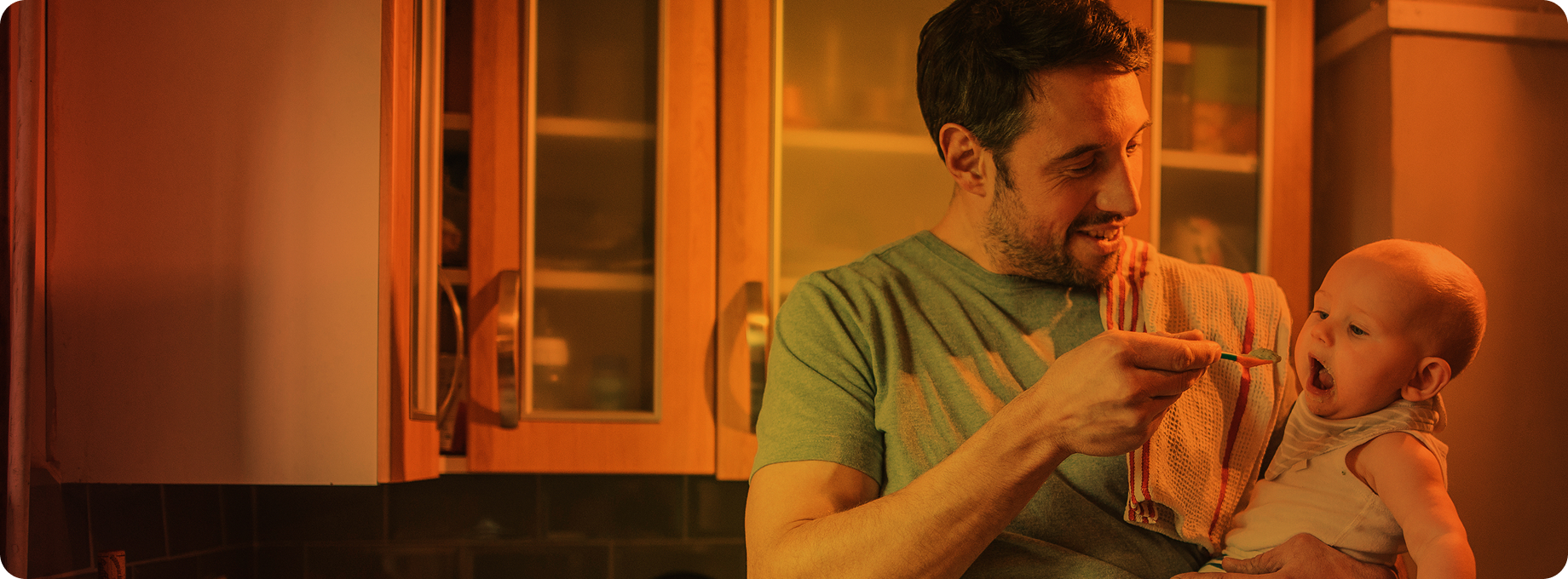 Man feeding baby